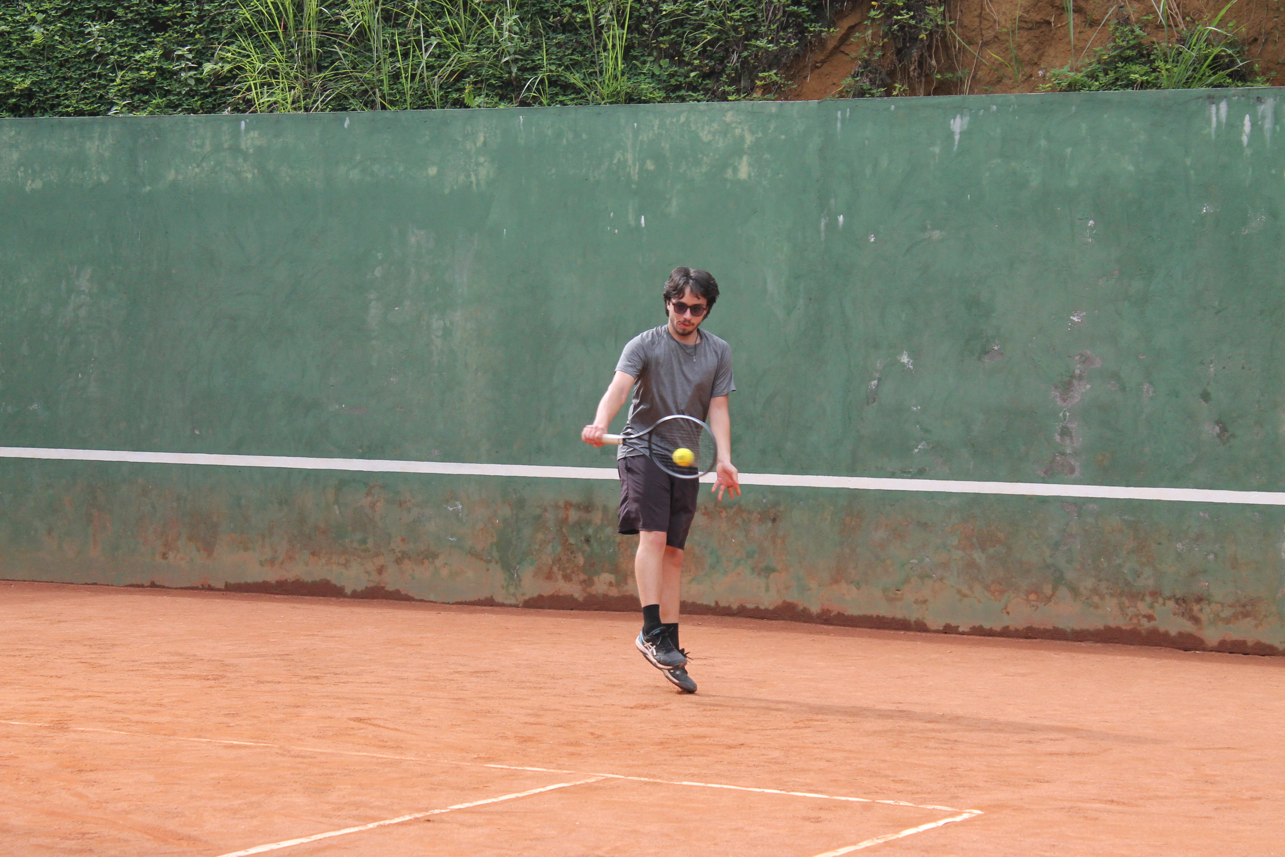 Dave Alzate, tennis coach in Regina SK, demonstrating a one-handed backhand during a lesson