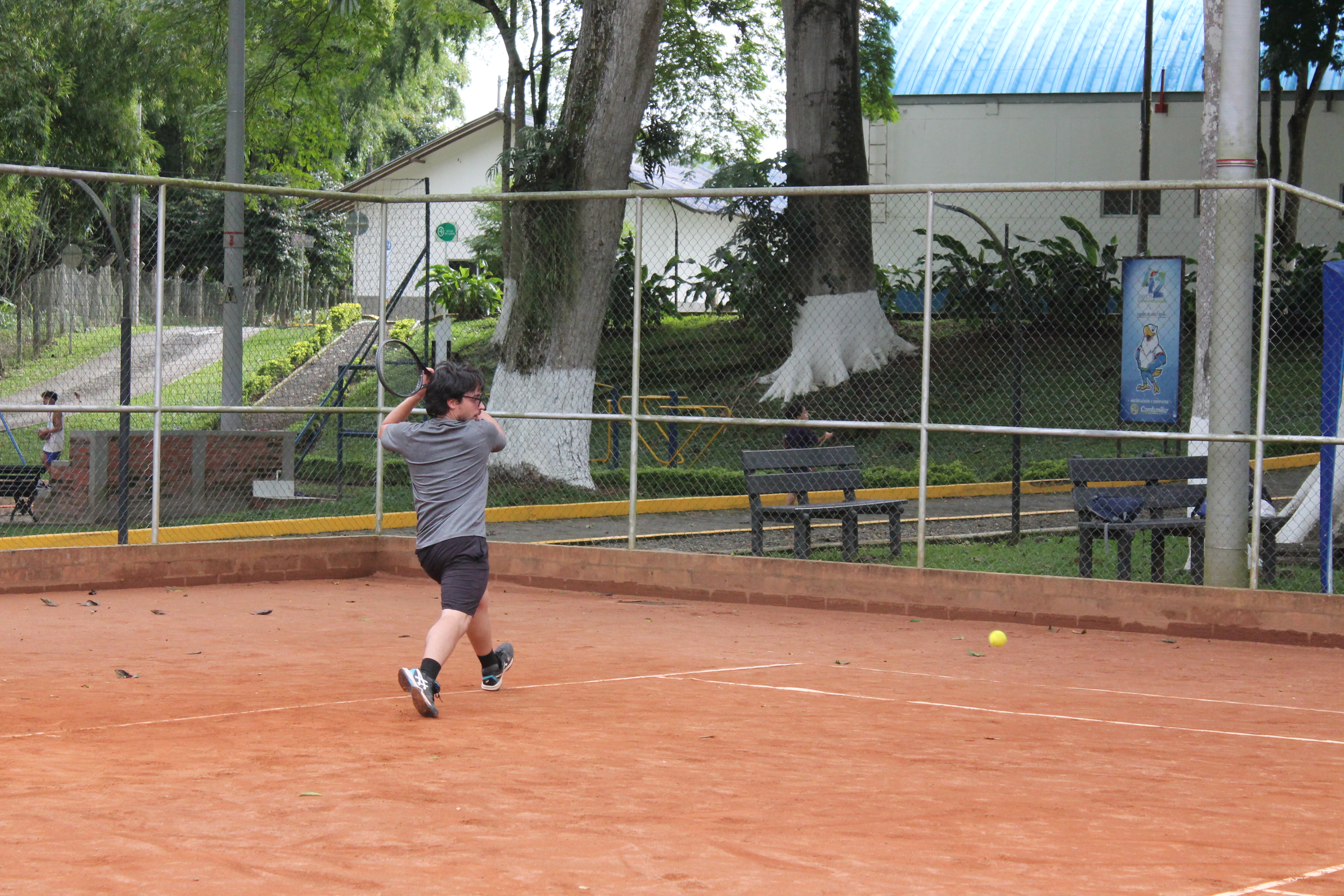 Dave Alzate, tennis coach in Regina SK, hitting a one-handed backhand during a training session